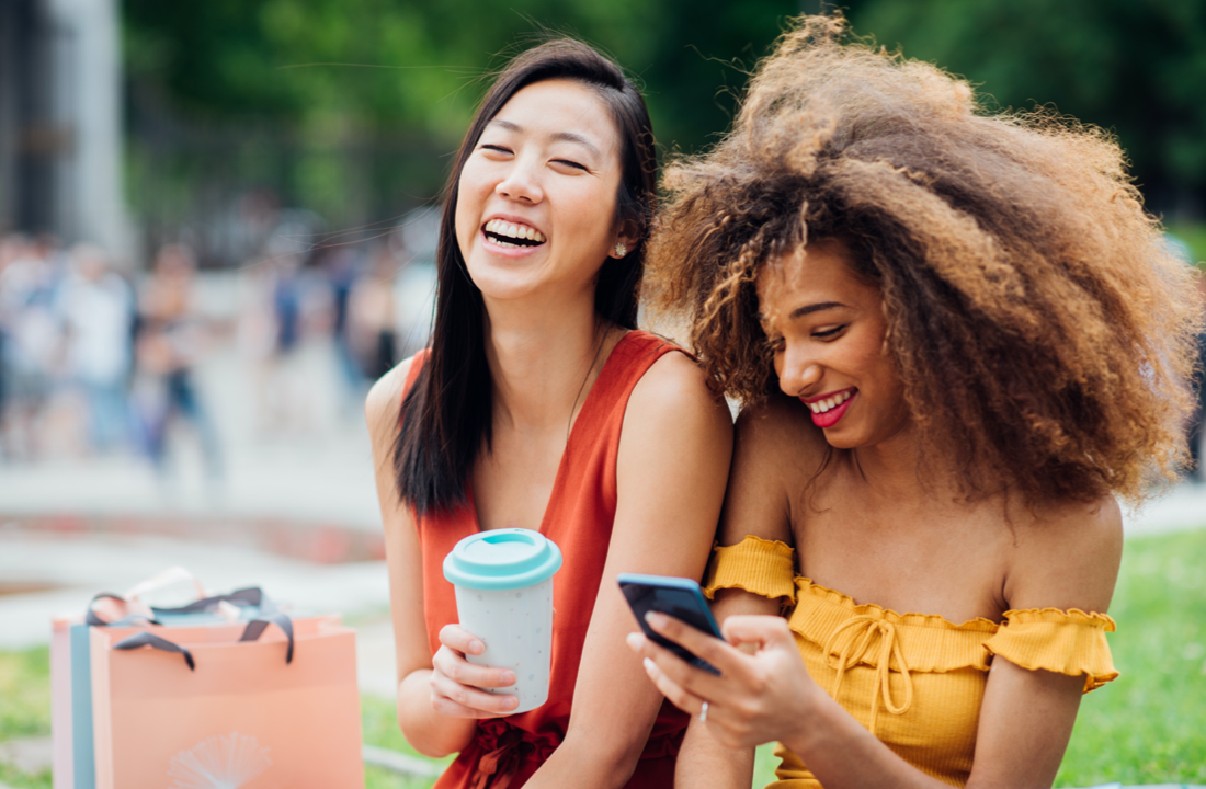 friends laughing while on phone 